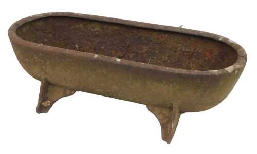 A cast metal feeding trough, of oval design, on four feet, 70cm wide. (AF)