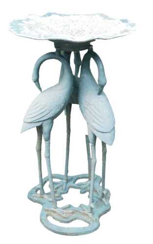 A cast stork bird table, with green over painted patination, and a leaf moulded bowl, 76cm high, 45cm wide.