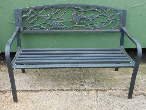 A metal two seated garden bench, the back with pierced bird decoration, on a slatted seat, 85cm high, 127cm wide, 56cm deep.