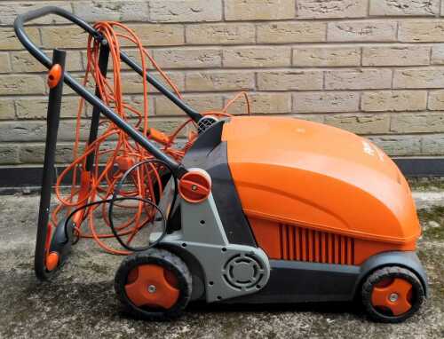 A Flymo Lawn Rake compact 3400 electric mower.