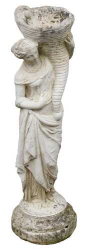 A reconstituted stone figure of a Neoclassical style female holding cornucopia, on a circular foot, 81cm high.