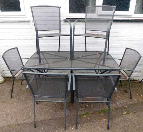 A metal rectangular garden table, with pierced top, and a set of six chairs, the table 71cm high, 145cm wide, 91cm deep.