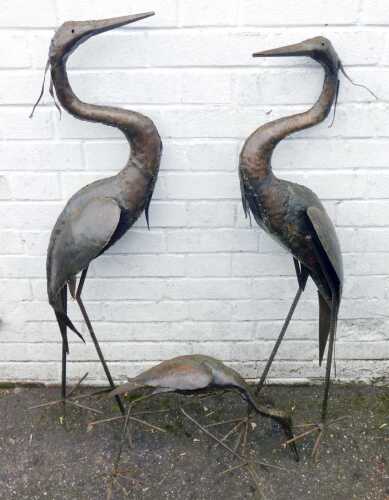 Three recycled metal garden storks, 24cm and 25cm high. (3)