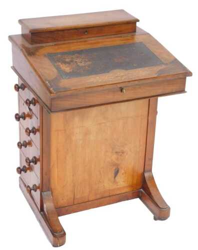 A Victorian walnut inlaid Davenport, the top with a hinged compartment above a hinged writing slope inset with leather panel enclosing a vacant interior, the base with four drawers to one side and dummy drawers to the other, on shaped base with castors, 7