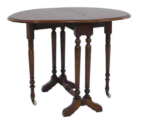 A Victorian walnut and marquetry Sutherland table, the oval top inlaid with boxwood and ebony scrolling and lead motifs, on cylindrical turned legs, with pot castors, 54cm high, 55cm wide, 14cm deep, 72cm extended.