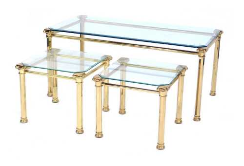 A 20thC brass framed and glass top nest of three tables, the largest table with a rectangular top, on Corinthian column style supports, 44cm high, the top 100cm x 50cm, together with two square examples, each 37cm high, the top 38cm x 38cm.