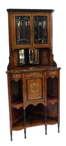 A Victorian rosewood and marquetry corner display cabinet, the top with swan neck pediment with central urn finial above two panelled glazed doors, with ivory inlay, with mirror back, above a mirrored recess, the base with a single cupboard flanked by two