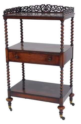 A Victorian rosewood whatnot, the pierced raised back above a recess with frieze drawer with a further recess to base, each section united by spiral turned supports, on compressed bun feet on castors, 108cm high, 63cm wide, 38.5cm deep.