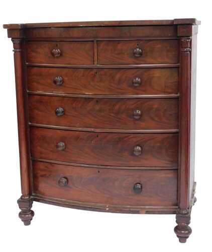 A Victorian flame mahogany bow fronted chest, of two short and four long drawers, flanked by turned pillars, on bun feet, 148cm high, 127cm wide, 65.5cm deep. (AF)