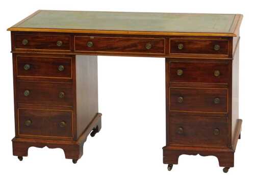 An early 20thC mahogany pedestal desk, the top with green tooled leather inset, with an arrangement of nine drawers, on bracket feet with castors, 75cm high, 120cm wide, 56cm deep.