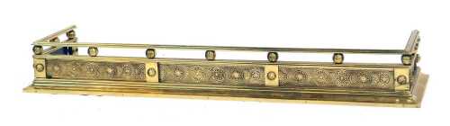 A Victorian brass fender, with floral roundel decoration, 142cm wide.