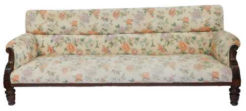 A Georgian style mahogany framed three seater sofa, with overstuffed floral fabric, raised on turned legs, 234cm wide.