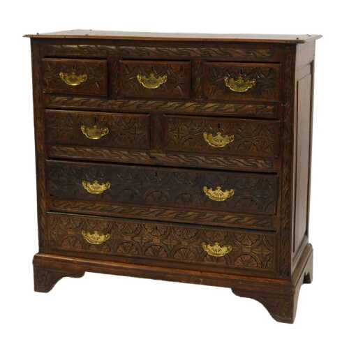 A 19thC oak chest, the front with three short above three long drawers, later carved, on bracket feet, 102cm high, 106cm wide, 47cm deep.