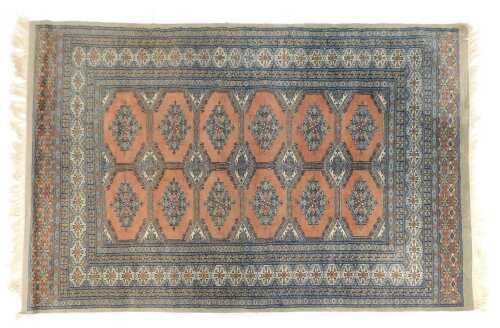 A Bokhara rug, pink ground decorated centrally with various medallions within multiple borders, 129cm x 198cm.