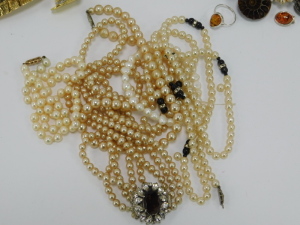A group of assorted costume jewellery,&nbsp;comprising cultured pearl necklace with 9ct clasp, clip on earrings, bangles, faux pearl necklaces, crystal longuards, Swarovski crystal pendant and chain, Newbridge silver pendant and chain, Mappin and Webb wristwat - 9