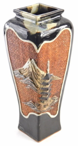 A Japanese stoneware vase, of tapered square section form, with panels of raised decoration, including figural characters, and landscape with a pagoda and Mount Fuji, within brown and grey running glazes, impressed signature to the base, 30.5cm high. - 2