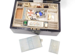 A Victorian ebonised work box, with mother of pearl inlay, the fitted interior with blue silk lining, padding, and papered lining, with various mother of pearl implements, bone bobbin thread winders, etc., and a small needlework sampler, 11cm high, 25cm w - 2