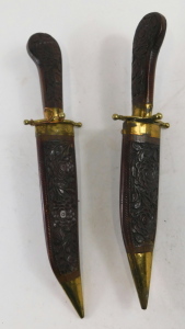 A Burmese dagger and fork set, with carved sheaths and grips, brass mounted, 33cm long overall. - 2