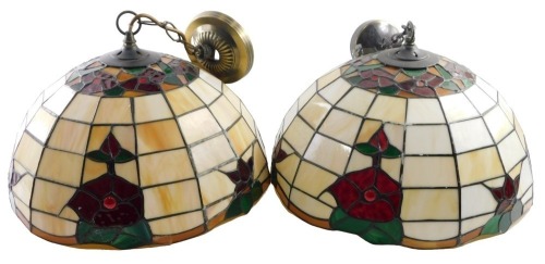 A pair of modern Liberty style leaded light pendant light shades, of dome shaped design with borders of coloured red and green glass, and mottled marbled cream and brown panels, 40cm diameter.