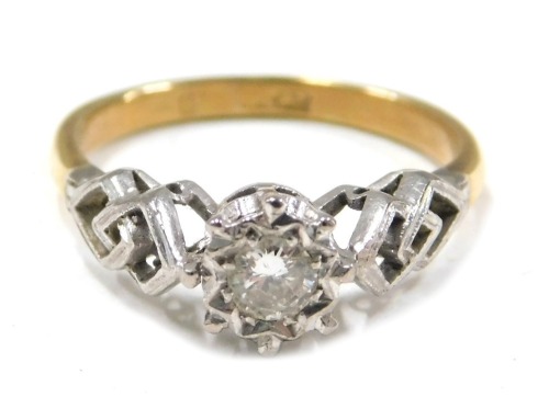 A diamond set dress ring, the round brilliant cut diamond approx 0.10ct, in a claw star setting, with interwoven shoulders, on white gold, on a yellow metal band unmarked, ring size J&frac12;, 2.3g all in.