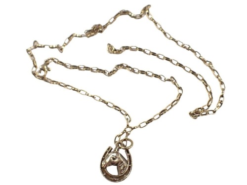 A pendant and chain, the pendant formed as a horse shoe with central horse head, yellow metal stamped 375, 2cm high, on box link neck chain, yellow metal stamped 375, 50cm long, 6.3g.