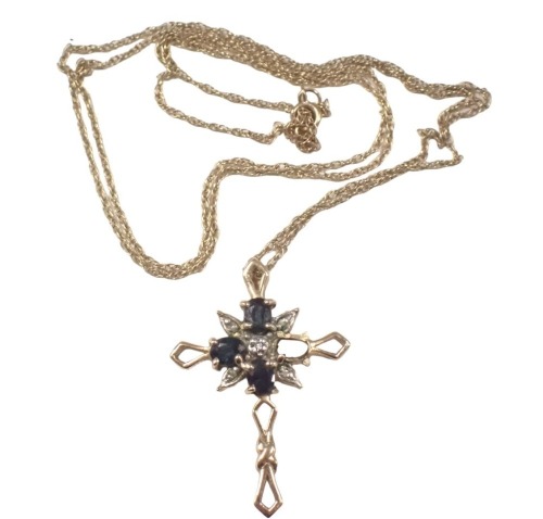 A Brooks & Bentley Midnight Star cross pendant, the pendant set with five diamonds and three sapphires, each claw set, 3cm high, on fine link neck chain, 48cm long, yellow metal stamped 375, 2.7g all in, boxed. (AF)