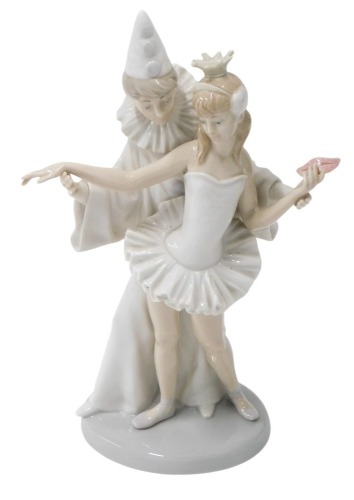 A Lladro figure group of a Pierot clown and masked ballerina, in standing pose, 26cm high.