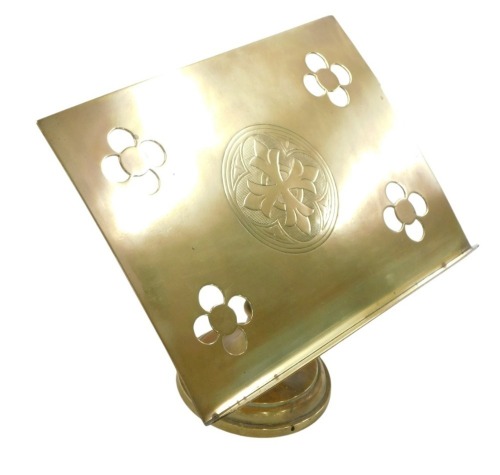 A 19thC brass church book stand, with pierced flower decoration and central engraved cross, on a circular foot, 30cm high, 31cm wide, and 20cm deep.