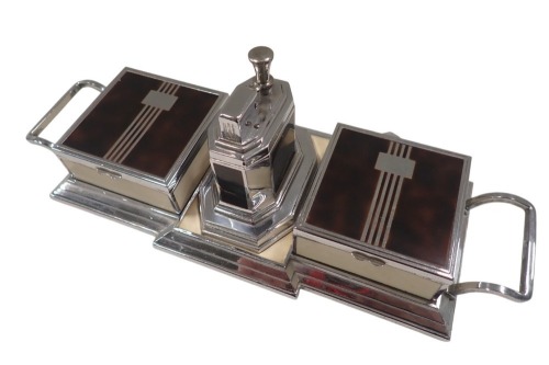 A Ronson Art Deco table lighter and cigarette set, on a cream and chrome ground, with two lid hinged sectioned and the centre chrome lighter, 31cm wide, 10cm deep.