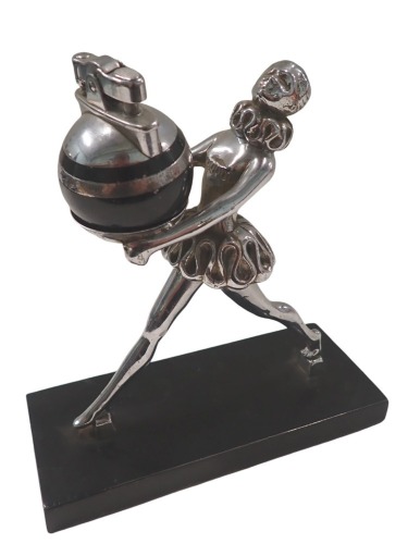 1950s/60s lighter, formed as a figure with ruffed collar, on a black metal base, with orbed lighter, 17cm high, 16cm wide, 7cm deep.