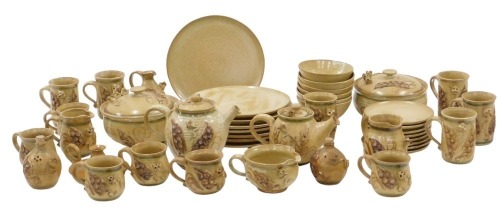 A Bernard Rooke Alvingham Mouse studio pottery part tea and dinner service, on brown stoneware ground, comprising eight large dinner plates, eight side plates, six bowls, two tureens and covers, six tea cups, coffee pot, teapot, three jugs, vinaigrette bo