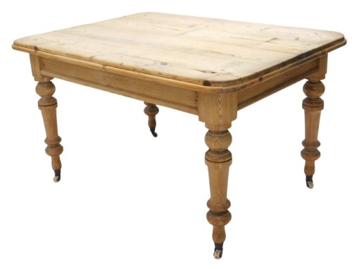 A Victorian pine scrubbed top kitchen table, with rectangular top, having moulded corners and border, on turned and tapered legs, with pot castors, 130cm x 92cm x 74cm high.