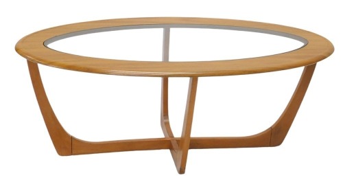 A 1970s oval coffee table, with plate glass centre, and teak effect top, on teak cross framed base, 106cm x 53cm.