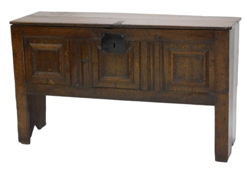 A small 18thC oak coffer, with plain hinged lid and triple panelled front, on stile legs, with iron lock plate, 70cm high, 118cm wide.