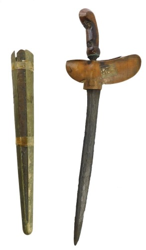 A 20thC Middle Eastern kris, the shaped and carved wooden handle of pierced design, with a carved shaped handle, with sheath, 46cm long.