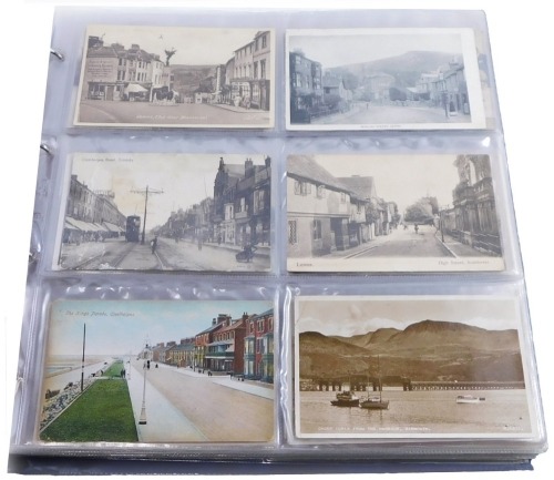 A 20thC postcard album, containing coloured and black and white postcards, for Lewes, Barmouth, Southport, Newmarket, and others, to include some at the races, military black and white photographs, etc. (1 album)