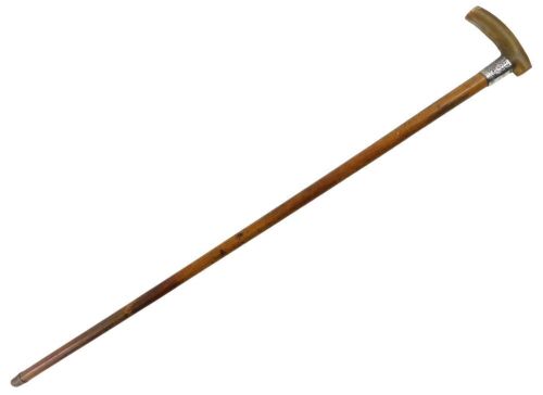 A 19thC walking stick, with carved horn handle and a silver collar with floral engraving, bearing the initials GW Robinson Lincoln, hallmarks rubbed, Chester assay, with brass cap end, 89cm long.