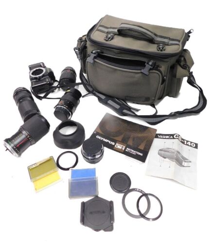 A quantity of camera lenses and lens caps, comprising a Vivitar 135mm lens, a Vivitar close focus auto lens, a Yashika 52mm lens MC, a Yashika 1-45 macro MC 55mm lens, a Yashika 52mm MC lens, a Yashika 108 camera, various lens caps, and a Vivitar auto wid