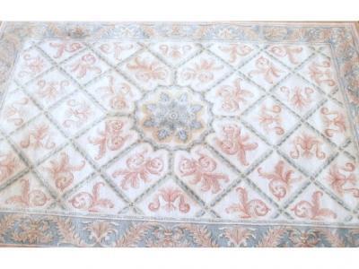 A fine handmade beige ground carpet