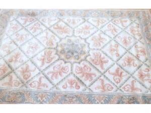 A fine handmade beige ground carpet