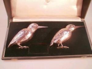 A pair of George V silver condiment castors in the form of kingfishers
