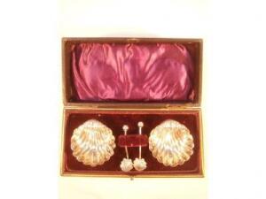 A pair of Victorian silver shell designed salts with spoons in fitted case