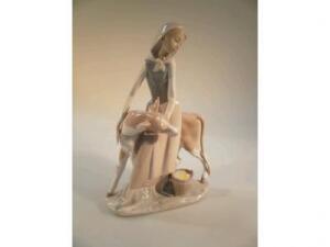 A Lladro figure group of a cow girl with a calf