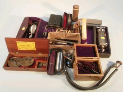 Vintage medical and veterinary equipment including a large syringe in case