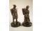 A pair of bronze patinated cast metal figures of male and female seaweed gatherers