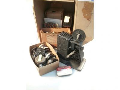 A vintage Coronet cine projector and a collection of approximately fifty