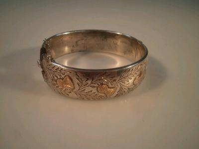 A silver hollow bangle with engraved Scottish thistle motif
