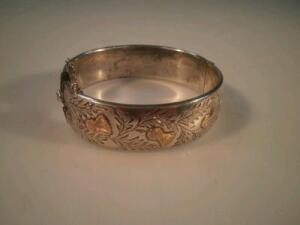 A silver hollow bangle with engraved Scottish thistle motif