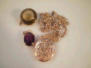 A locket on chain stamped 9c and two stone set pendants