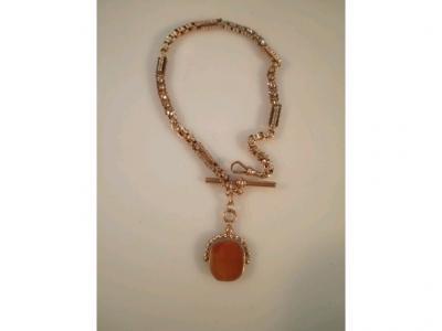 A fancy link Albert, stamped 9ct with a double agate faced fob attached,